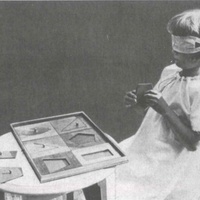 Girl working with geometric insets in a Berlin Children's House, before 1927 - T. Müller, R. Schneider, <em>Lehrmaterialien 1913-1935. Möbel und Architektur. Techning Meterials 1913-1935. Furniture and Architecture</em>, München, Prestel Verlag, 2002, p.29.$$$370