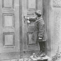 A boy cleaning the door handle. Children's House, Berlin-Lankwitz, 1919-22. Photograph from 1920 - T. Müller, R. Schneider, <em>Lehrmaterialien 1913-1935. Möbel und Architektur. Techning Meterials 1913-1935. Furniture and Architecture</em>, München, Prestel Verlag, 2002, p.80$$$422