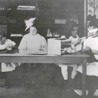 Scuola Montessori, Stati Uniti d'America Girls doing the touch exercises with pieces of fabric. The girl on the right is blindfolded so as to concentrate all her attention on the sense of touch. The photograph, from 1912, belonged to S. S. McClure of New York, the publisher of the famous McClure's Magazine, which in 1911/12 published a number of articles and photographs and had a decisive influence on the birth of the American Montessori movement. This photograph (like the other photographs by McClure in this book) was probably taken in the first American Children's House in Tarrytown N.Y., which was set up in 1911 and whose charges were all "from cultured families." (Kramer, p. 163) - T. Müller, R. Schneider, <em>Lehrmaterialien 1913-1935. Möbel und Architektur. Techning Meterials 1913-1935. Furniture and Architecture</em>, München, Prestel Verlag, 2002, p.93$$$455