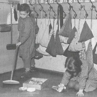 Vita pratica Housework is one of the exercises that children choose very eagerly. Here two children are polishing the floor. The necessary materials are kept in their place and put back again when the work has been completed. Montessori nursery, Berlin-Tempelhof, 1955 - T. Müller, R. Schneider, <em>Lehrmaterialien 1913-1935. Möbel und Architektur. Techning Meterials 1913-1935. Furniture and Architecture</em>, München, Prestel Verlag, 2002, p.80$$$420