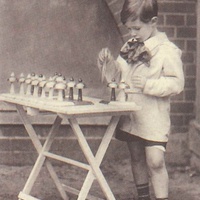 A boy placing the bells in the right order. Postcard published by the DMG (German Montessori Society), around 1927 - T. Müller, R. Schneider, <em>Lehrmaterialien 1913-1935. Möbel und Architektur. Techning Meterials 1913-1935. Furniture and Architecture</em>, München, Prestel Verlag, 2002, p.95$$$459